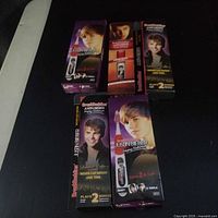 Front view of five boxed Justin Bieber BrushBuddies toothbrushes