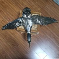 Front view of carved loon with wings spread