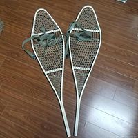 Full view of both snowshoes showing frames, webbing and bindings