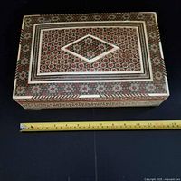 Top view of rectangular khatam inlaid box next to ruler showing 12-inch length