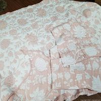 Overall view of reversible coverlet and shams laid out