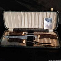 Complete carving set in open case showing knives and fork