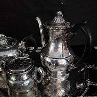 Close-up of coffee pot, condiment pot and portion of tray