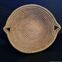 Top view of round seagrass basket showing weave pattern and handles