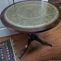 Top view showing green leather insert with gold tooling and wood edge