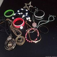 Top view of all jewellery pieces on black surface