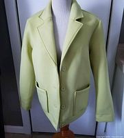 Front view of light yellow blazer on mannequin