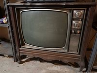 Front view of Electrohome wood console TV showing CRT screen, control panel, cabinet style and wear