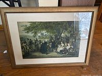Lithograph print of group under tree in brown frame