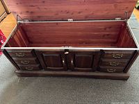 Chest open showing cedar interior, exterior drawers and doors visible