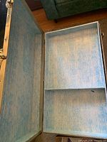 open trunk showing blue patterned interior lining and divider