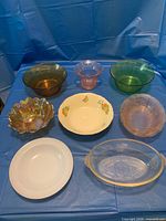 All eight assorted vintage glass and ceramic pieces arranged on blue background