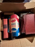 Box containing six hardcover dictionaries/reference books