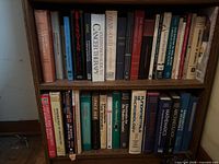 Two shelves of assorted science and humanities books, spines visible