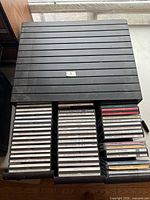 Drawer opened showing roughly 40 CDs in jewel cases