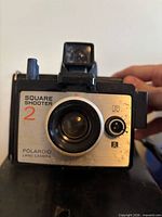 Front view of Polaroid Square Shooter 2 camera showing lens and branding