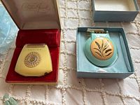 Both vintage ladies shavers in their open boxes on tabletop