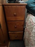 Front view of the solid wood 3-drawer nightstand showing drawers, knobs and finish