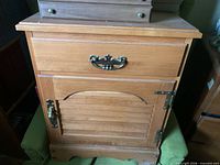 Front view showing drawer, cabinet door, brass hardware, overall finish and wear
