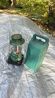 Lantern beside green plastic carry case