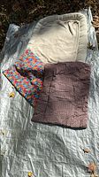 all three dog beds on tarp, showing size difference and colors