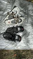 Both pairs of snowshoes laid out on tarp