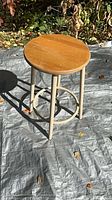 Overall view of stool showing wooden seat and legs