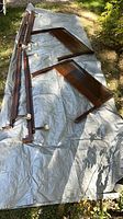 All components: two wooden headboards and four frame rails on tarp