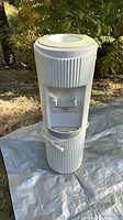 front view of white floor standing water cooler with spouts and cord