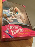 Front view of boxed Dentist Barbie showing dolls and accessories