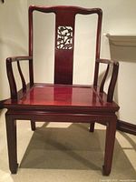 Front view of carved mahogany-finish armchair