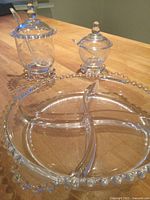 overall view of divided tray and two jars with lids and spoons