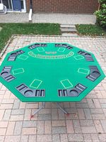 Full view of octagonal green felt blackjack tabletop on stand
