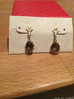 Front view of earrings on card showing overall design