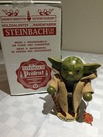 Yoda nutcracker standing beside branded Steinbach box