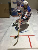 Figure on ice-style base with stick and skates visible