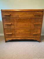 Full front view of Art Deco waterfall dresser showing three drawers and carved details