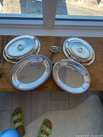 Four silverplate serving pieces on table