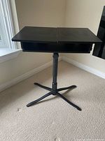 Front view of laptop desk showing split tilting top and star base