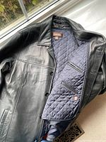 Interior view displaying navy quilted lining and interior zip pockets