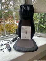 Massage cushion with remote, adapter and manual displayed