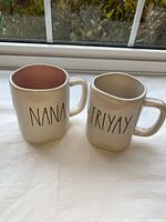 Front view of both mugs showing text NANA and FriYAY