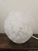 Lamp unlit displaying frosted glass and floral pattern