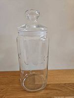 Full view of jar with lid showing floral etch and shape