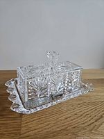 Covered crystal butter dish on matching tray with spreaders