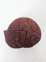 Top view showing carved cat face and puzzle lid