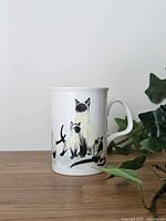 Front view of Roy Kirkham Siamese cat mug