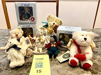 Group shot showing three boxed figurines and seven assorted plush/cloth bears