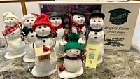 Group shot of seven snowmen and riser box