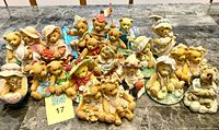 Full lot of approximately 19 Cherished Teddies figurines displayed on table
